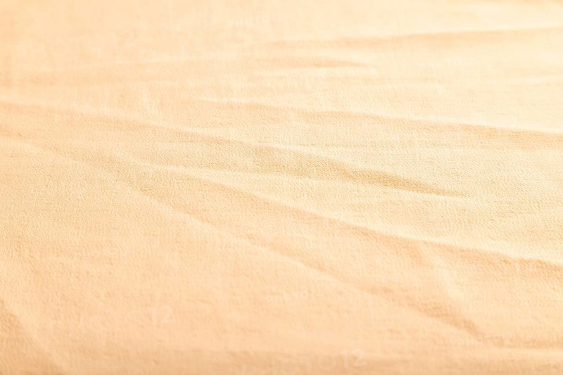 Fragment of smooth orange linen tissue. Side view, natural textile background and texture