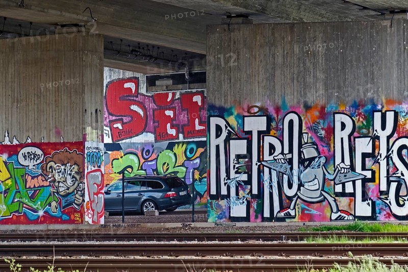 Colourful graffiti on a concrete wall in a subway with parked cars, Rhineland-Palatinate, Germany, Europe