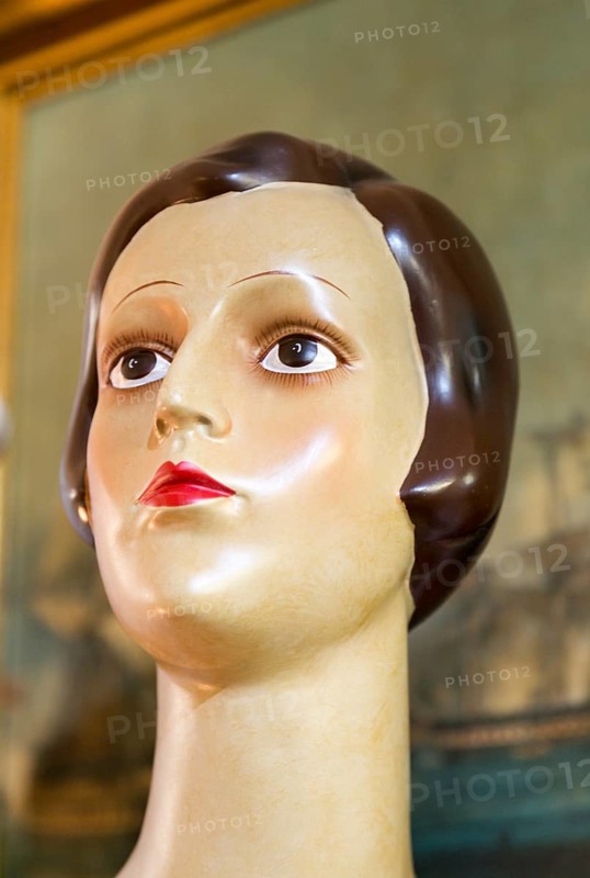 Female mannequin head close up 1920s haircut style, inside antiques centre, Marlesford Mill, Suffolk, England, UK