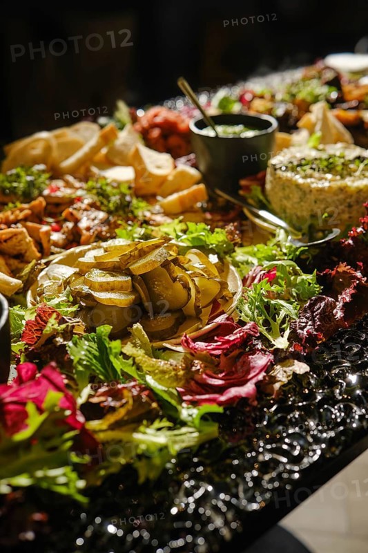 A table is beautifully arranged with a variety of Middle Eastern appetizers, featuring fresh herbs, colorful garnishes, and diverse dishes, creating an inviting atmosphere for a social gathering