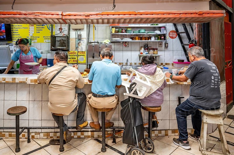 Visitors sitting at a food stall at the counter, Mercado Central de San José, San José, Costa Rica, Central America