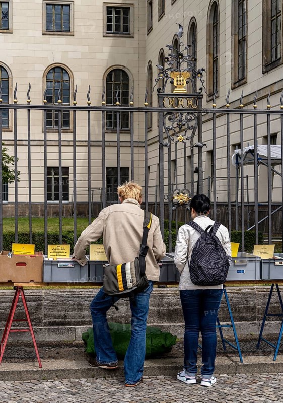 Tourists at the flea market stall in front of Humboldt University, Unter den Linden, Berlin, Germany, Europe