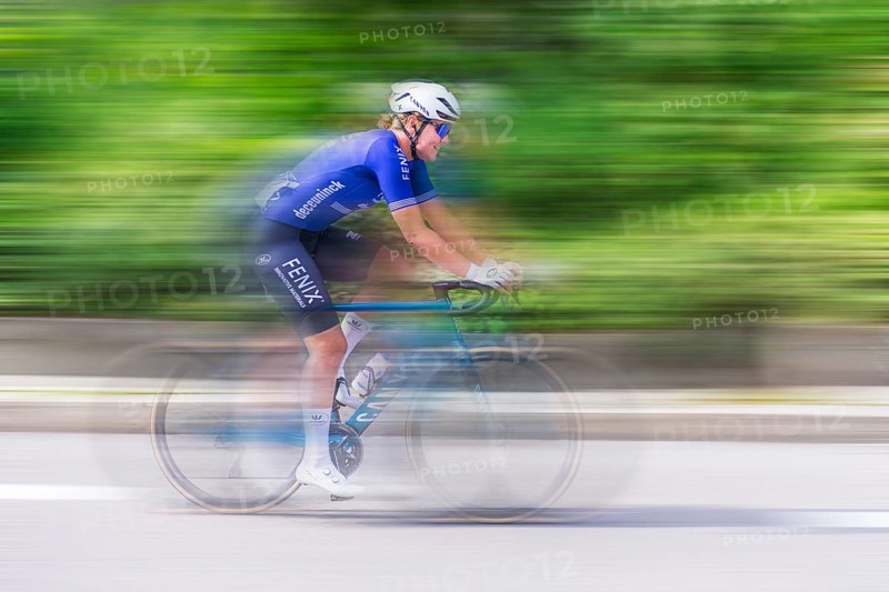Cyclist in blue jersey riding fast on a road, movement and speed blur the image, race, Stuttgart, Baden-Württemberg, Germany, Europe