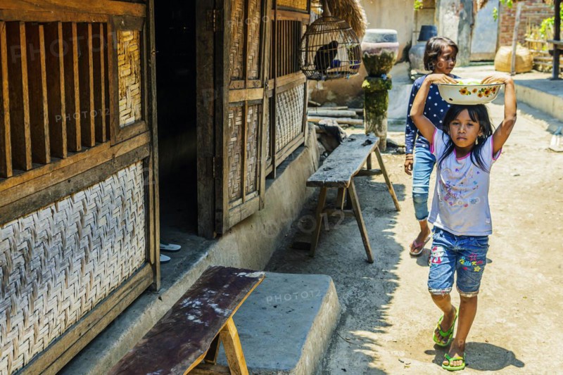 Children on the street in an Indonesian village, village, child, girl, childhood, carefree, lifestyle, village life, street child, street scene, Asian, authentic, local, tradition, traditional, travel, tourism, culture, poverty, person, Sasak, indigenous, indigenous people, cultural heritage, portrait, human, Sade village, Lombok, Indonesia, Asia