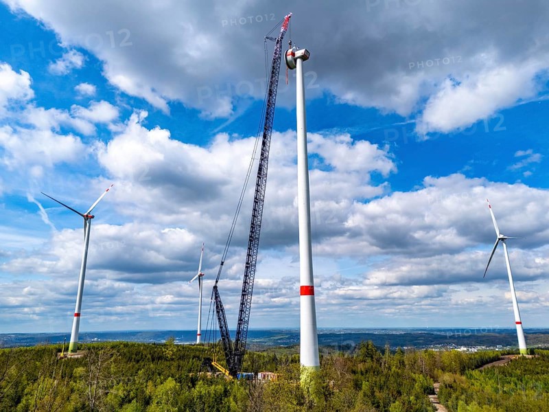 Erection of a wind turbine, wind energy plant, assembly of the ring generator, with a crawler lattice crane, wind farm near Hagen, North Rhine-Westphalia, Germany, Europe