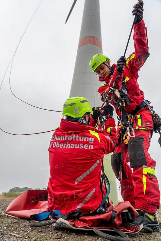 Height rescuers from the Oberhausen professional fire brigade practise abseiling from a wind turbine from a height of 150 metres, rescuing an injured person, technician, from the nacelle, Issum, North Rhine-Westphalia, Germany, Europe