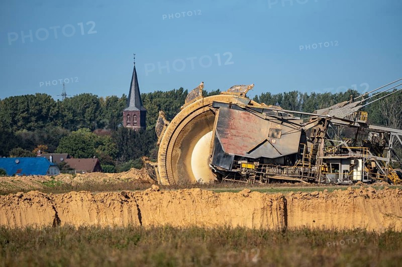 Opencast lignite mine Garzweiler II, bucket wheel excavator during excavation, at the edge of the opencast mine near the village of Keyenberg, village church, belongs to Erkelenz in the district of Heinsberg, North Rhine-Westphalia, Germany, Europe