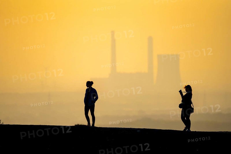 The Haniel spoil tip, 185 metres high, at the Prosper Haniel mine, closed in 2019, people on the way to the spoil tip, behind the decommissioned Voerde coal-fired power station, Bottrop, Germany, Europe