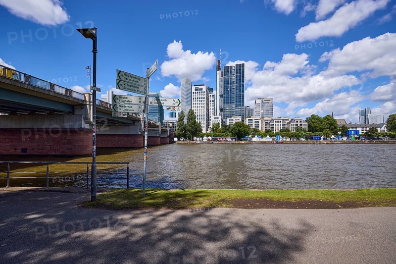 Untermainbrücke, signpost, riverside promenade, Main and skyscrapers under blue sky with cumulus clouds in Frankfurt am Main, Hesse, Germany, Europe