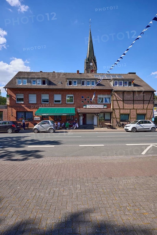 Weseler Strasse with building and church tower of St. Pankratius in the Buldern district, Dülmen, Münsterland, Coesfeld district, North Rhine-Westphalia, Germany, Europe