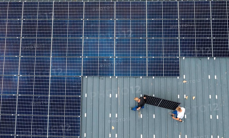 Installation of solar modules on the roof of a barn on a farm, over 210 photovoltaic modules are installed on the roof, North Rhine-Westphalia, Germany, Europe