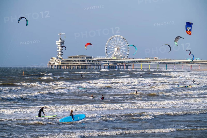 The pier and Ferris wheel at Scheveningen beach, strong swell, windsurfers, kitesurfers, surfers, Netherlands