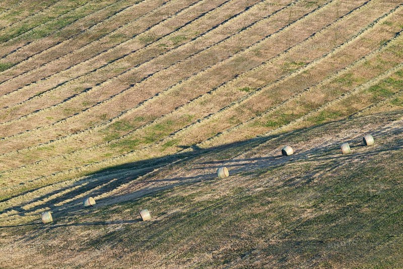 Harvested wheat field with bales of straw, landscape around Pienza, Val d'Orcia, Orcia Valley, UNESCO World Heritage Site, Province of Siena, Tuscany, Italy, Europe