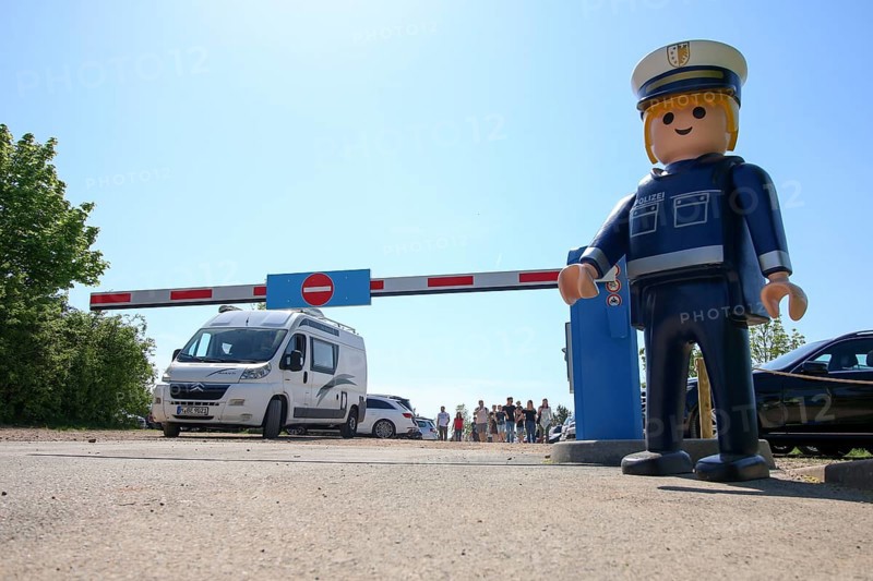Playmobil-Firgur, behind it car park with barrier, Zirndorf, Bavaria, Germany, Europe