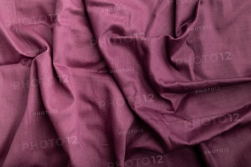 Fragment of cotton purple tissue. Top view, natural textile background and texture. wave concept, abstract