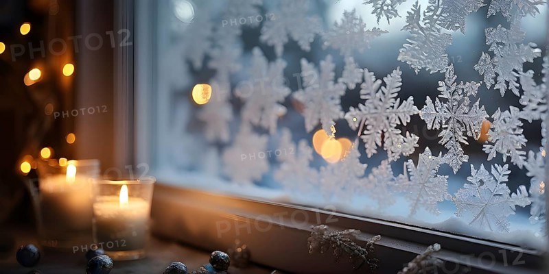 Snow-covered window with frost patterns, candlelight softly glowing through the glass, and warm, blurry Christmas lights in the background, AI generated