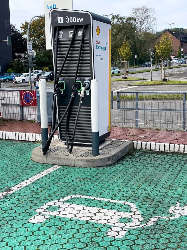 E-charging column Charging column for e-cars Electric cars 300 kw with various connections on the floor Pictogram for e-cars on the side Shell brand logo at petrol station, Germany, Europe