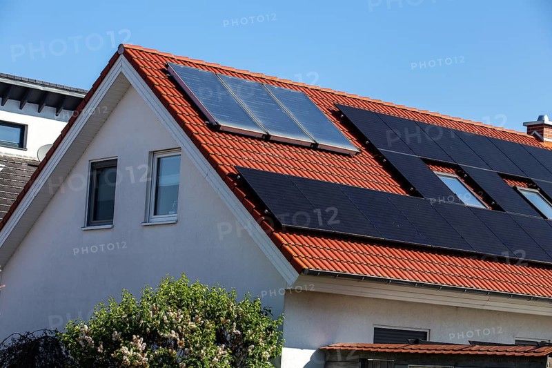 Detached house with photovoltaic system and collectors for solar thermal energy