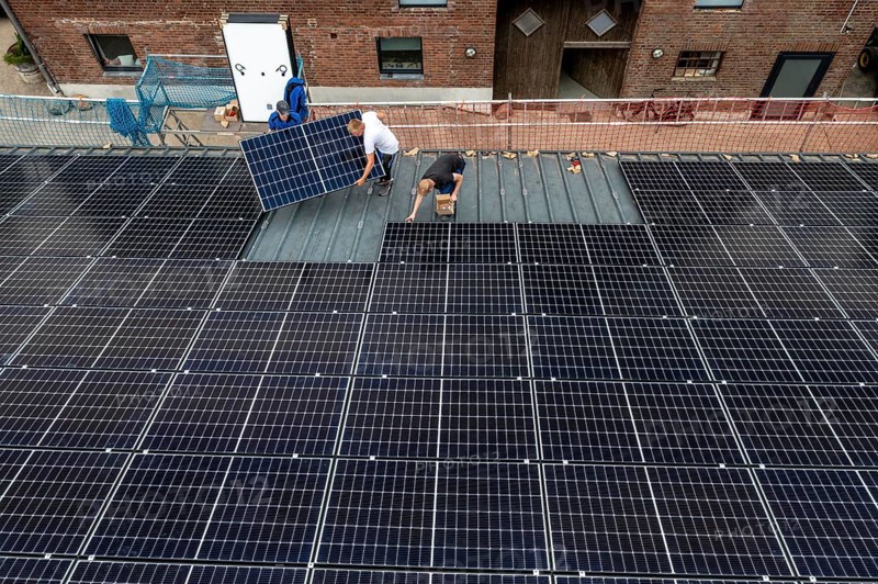 Installation of solar modules on the roof of a barn on a farm, over 210 photovoltaic modules are installed on the roof, North Rhine-Westphalia, Germany, Europe