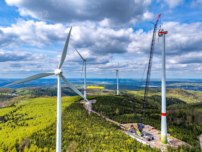 Erection of a wind turbine, wind energy plant, assembly of the ring generator, with a crawler lattice crane, wind farm near Hagen, North Rhine-Westphalia, Germany, Europe