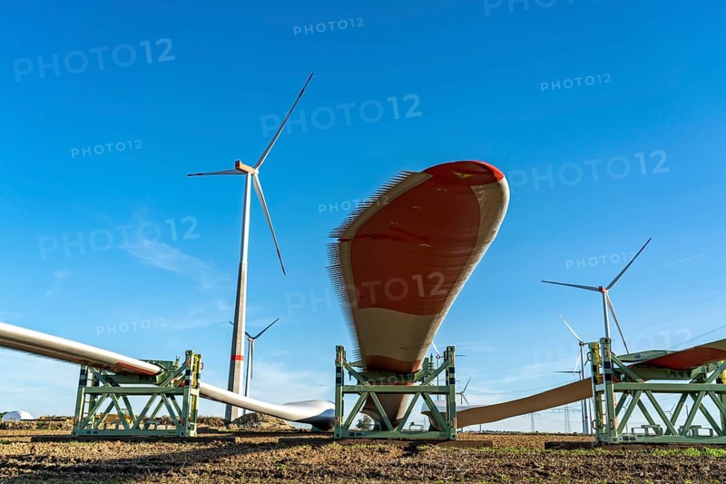 Wind farm near Bad Wünnenberg, construction site, toothing on the rotor blades, so-called Enevoldsen or Dinotails, are intended to reduce the noise of the rotors, storage area for a new wind turbine, components of the mast, the nacelle and the rotors are ready for assembly, North Rhine-Westphalia, Germany, Europe
