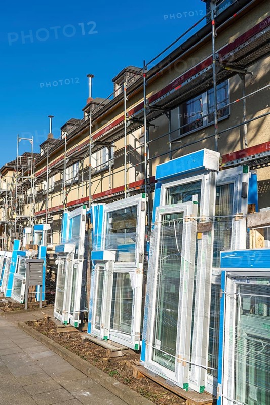Energy-efficient refurbishment of residential buildings, older apartment block is scaffolded, gets thermal insulation and new windows, Germany, Europe