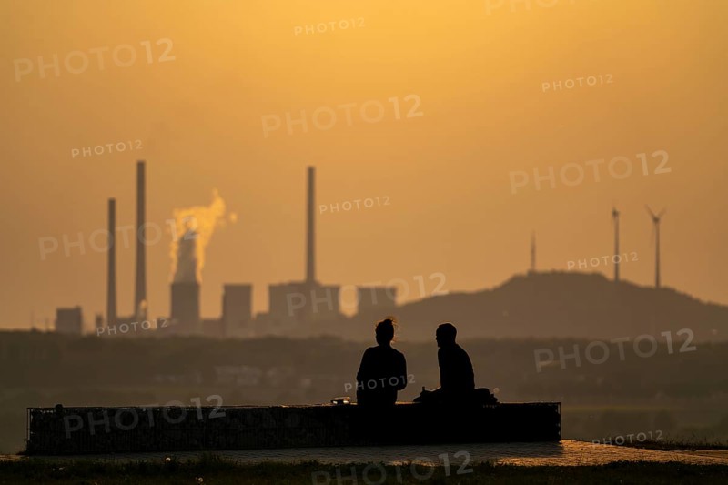 Evening atmosphere on the Hoheward spoil tip, the largest spoil tip in the Ruhr area, between Herten and Recklinghausen, with the Scholven power station in Gelsenkirchen, North Rhine-Westphalia, Germany in the background