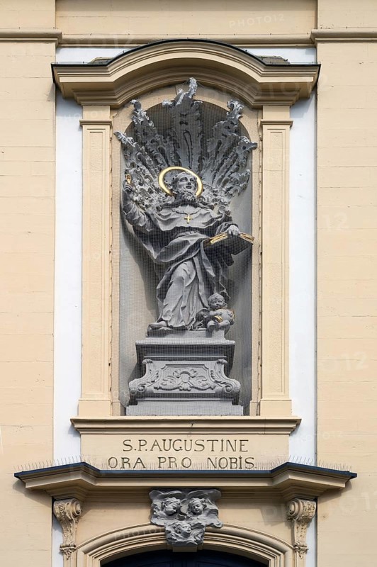 Figure of St Augustine in a niche above the entrance portal of St Augustine's Church, Dominikanerplatz, Würzburg, Lower Franconia, Bavaria, Germany, Europe