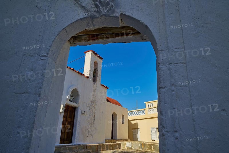 View through an arch of a traditional building against a clear blue sky, Agios Ioannis church, Mesochori village, west coast, Karpathos, Dodecanese, Greek Islands, Greece, Europe