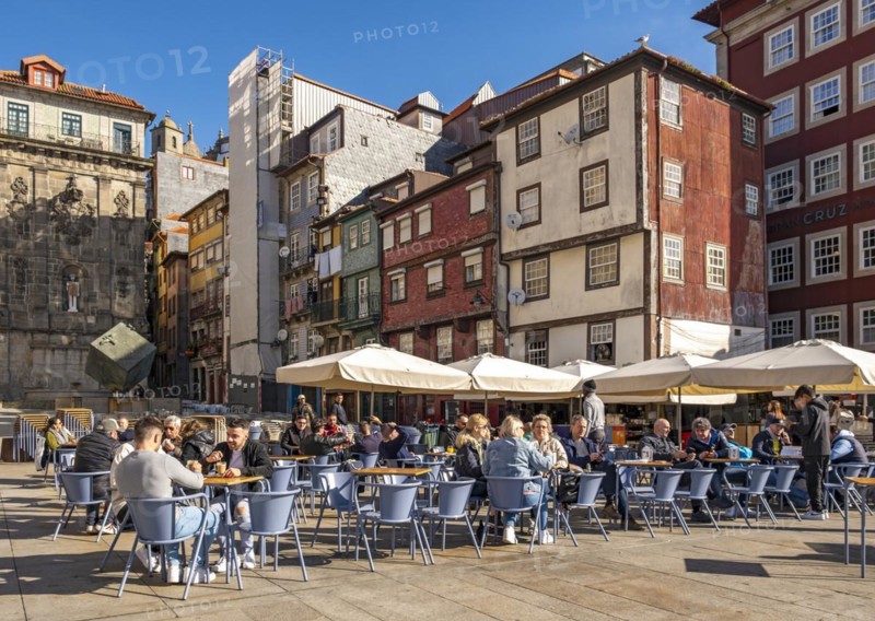 Diners enjoy outdoor restaurants at Praça da Ribeira, the historic Ribeira Square in Porto, Portugal, Europe