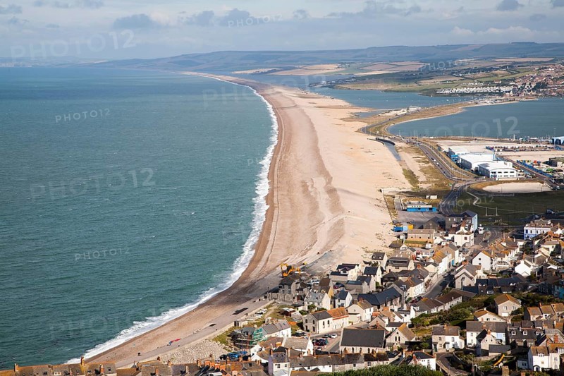 Chesil beach tombolo with housing in Chiswell in the foreground, Isle of Portland, Dorset, England, United Kingdom, Europe