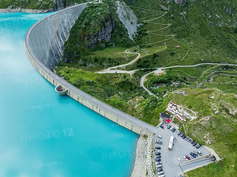 Dam of the Moiry lake, Lac de Moiry, turquoise glacial water, parking lot and restaurant at the dam, aerial view, Valais, Switzerland, Europe