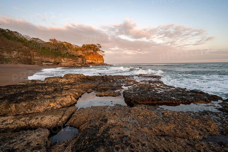Sandy beach beach with rocks and sea at sunset, Playa Cocalito, coastal landscape, Pacific coast, Nicoya Peninsula, Puntarenas Province, Costa Rica, Central America