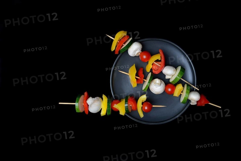 Colourful vegetable skewers on a plate, barbecue skewers