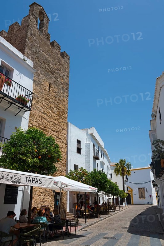 Narrow street with tapas restaurants and historic buildings, lively and sunny, part of the city wall, old town, Vejer de la Frontera, Cadiz province, Cadiz, Andalusia, Spain, Europe