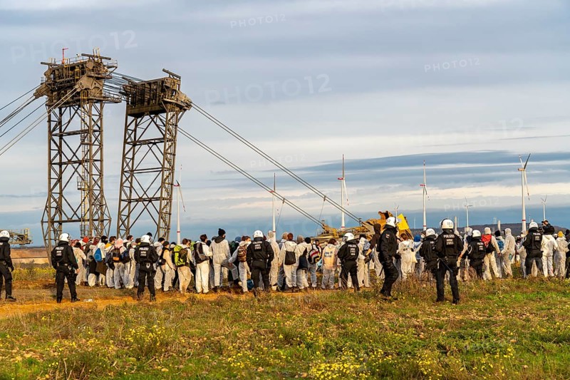 Protest action against the demolition of the village of Lützerath in the Rhenish lignite mining area, which is to make way for the expansion of the Garzweiler II open-cast mine, activists wanted to occupy an excavator, but were stopped by the police at the edge of the spoil heap, Lützerath, North Rhine-Westphalia, Germany, Europe