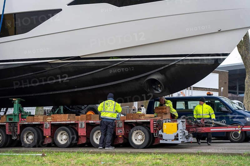 Craning the €6.3 million Sunseeker 88Y motor yacht, weighing 82 tonnes, in preparation for the world's largest water sports trade fair, Boot in Düsseldorf, luxury yachts are driven across the Rhine to the trade fair and brought ashore with the help of the Big Willi ship crane and transported to the exhibition halls on a low-loader, North Rhine-Westphalia, Germany, Europe