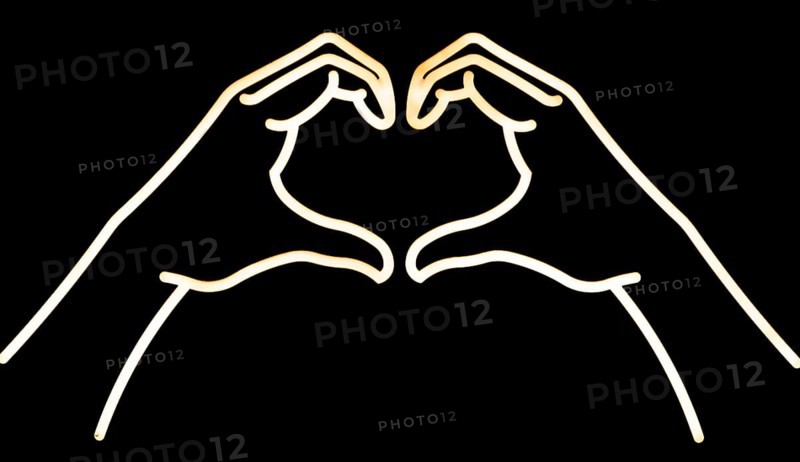 Electric neon lights of hands forming heart shape, Marlborough, Wiltshire, England, UK