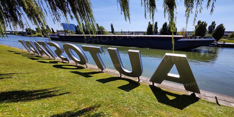 Lettering Autostadt am Mittellandkanal with passing barge, Wolfsburg, Lower Saxony, Germany, Europe