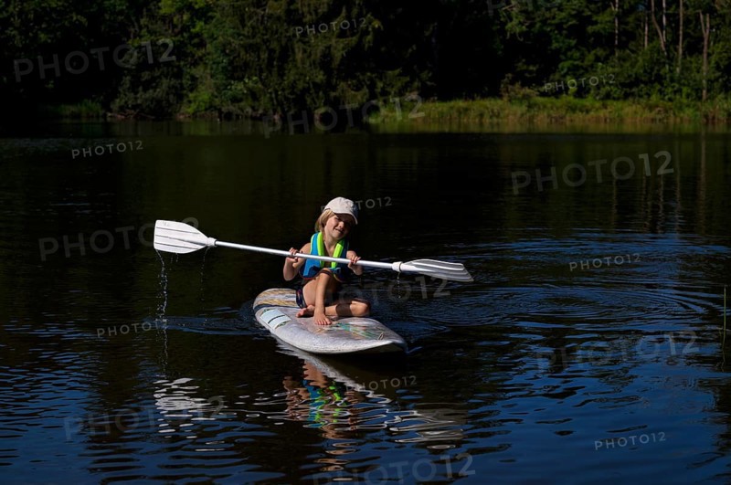 Little boy, 4 years old, paddling on surfboard, surfboard, lake, Schwaltenweiher, honey village Seeg, Allgäu, Bavaria, Germany, Europe