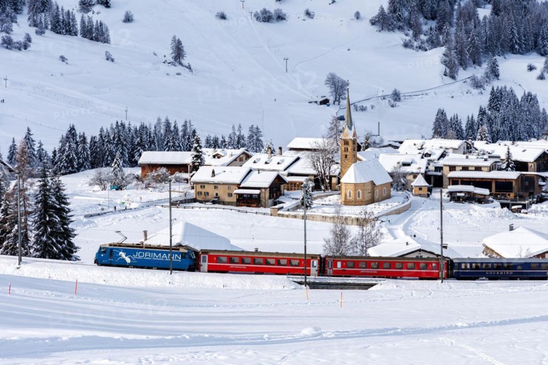 Rhaetian Railway train on the Albula railway Passenger train in the Alps in Bergün, Switzerland, Europe