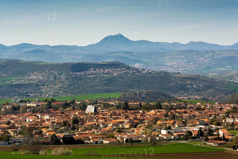 View on Vic le Comte village, Puy de Dome volcano in background, Limagne plain, Puy de Dome department, Auvergne Rhone Alpes, France, Europe