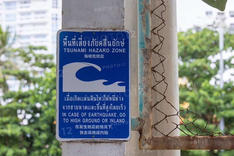 Tsunami Hazard Zone. Warning sign, signposting of escape routes in the event of another seaquake. Beach area and coastal road in the town of Patong, Kathu, Phuket Island, Thailand, Asia