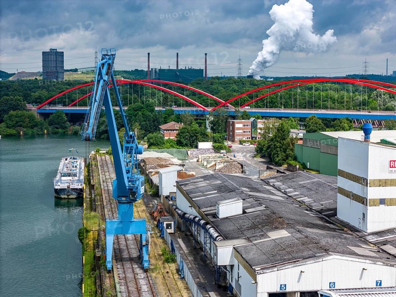 DefaultThe city harbour in the north of Essen, on the Rhine-Herne Canal, North Rhine-Westphalia, Germany, The city harbour in the north of Essen, dilapidated bridge of the A42 over the canal, ArcelorMittal's coking plant in the background, Prosper coking plant, Europe