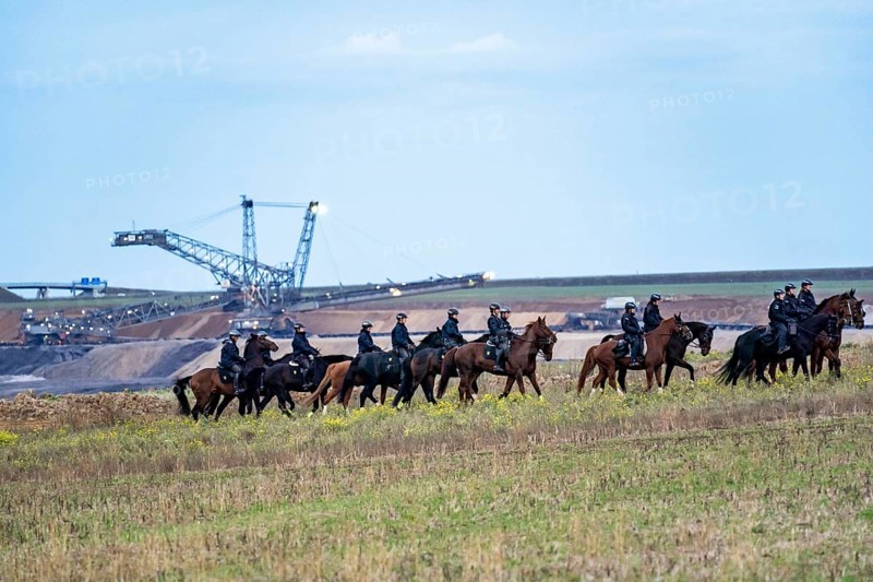 Police deployment, equestrian squadron, at the protest against the demolition of the village of Lützerath in the Rhenish lignite mining area, which is to make way for the expansion of the Garzweiler II open-cast mine, several thousand participants at the demonstration in Lützerath, North Rhine-Westphalia, Germany, Europe