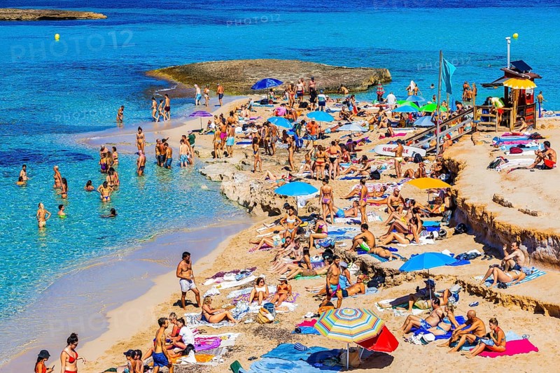 Bathers and sunbathers on the beach of Cala Comte bay, Ibiza, Balearic Islands, Mediterranean Sea, Spain, Europe