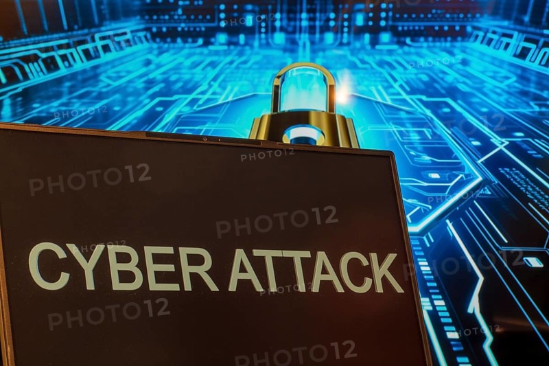 Cyber attack symbol: Laptop in front of a virtual computer background