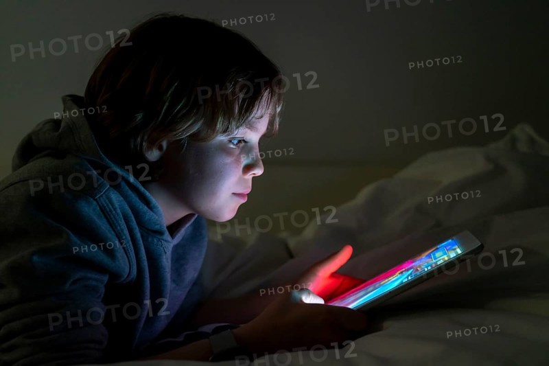 A boy plays computer games on a tablet PC