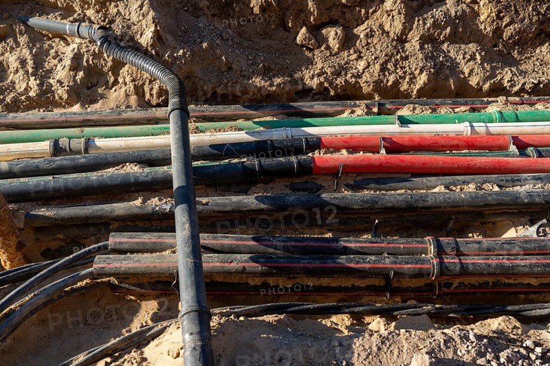 Cables, pipes, next to each other in a construction site, supply lines exposed during construction work, Schadowstraße in Düsseldorf