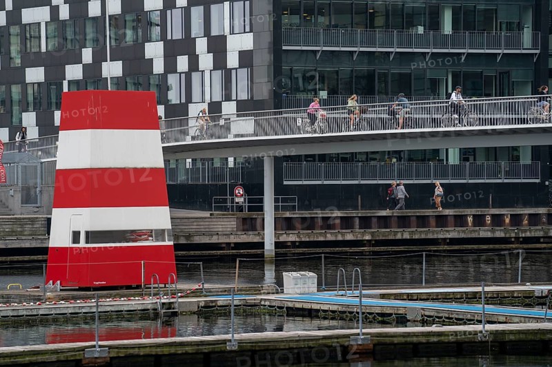 Cyclists on the Cykelslangen cycle and footpath bridge, at the Fisketorvet shopping centre, across the harbour, harbour outdoor pool, Sydhavnen, Copenhagen is considered the cycling capital of the world, 45 % of the population travel by bike, Denmark, Europe